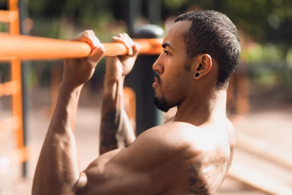 A shirt less guy doing chin up a best bicep workout.