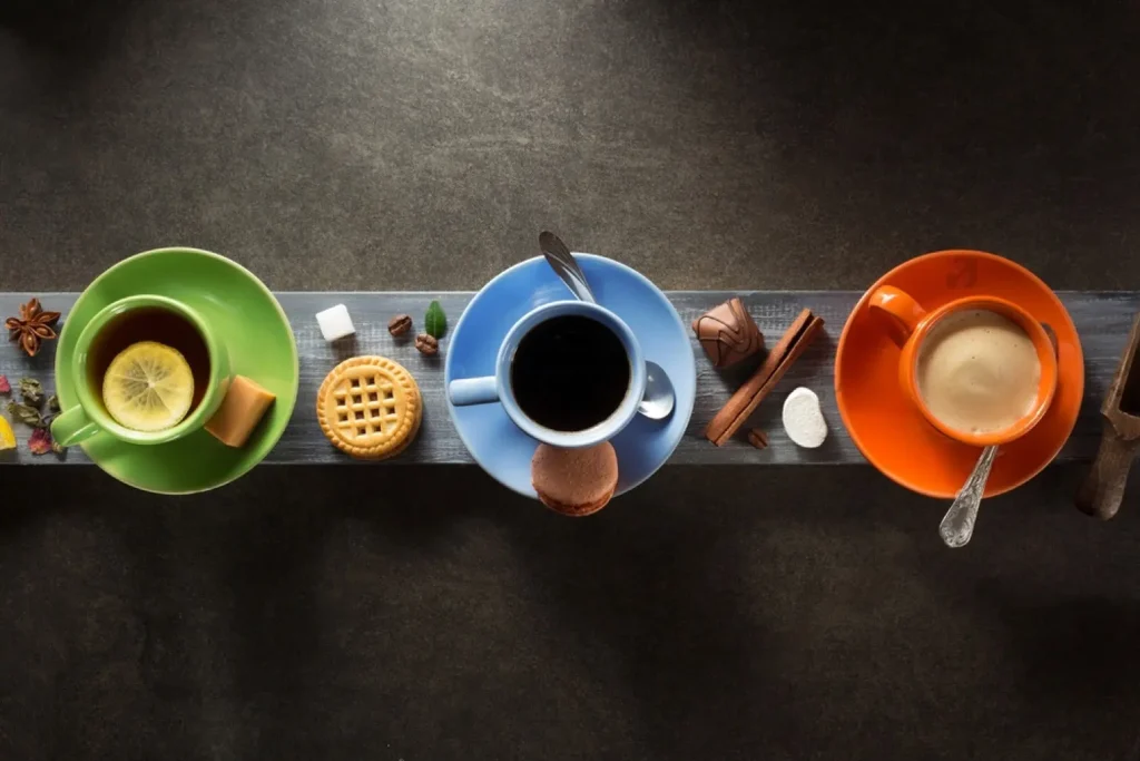 Cup of coffee cacao and green tea on wooden background.