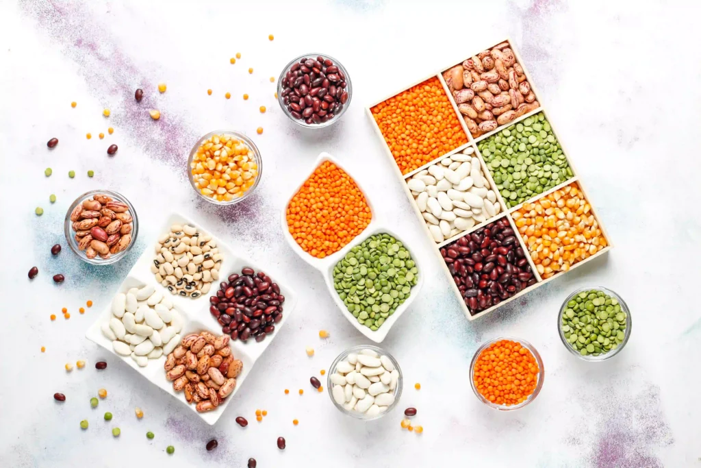 A collection of legumes various beans displayed in bowls, showcasing their diverse shapes, colors, and textures.