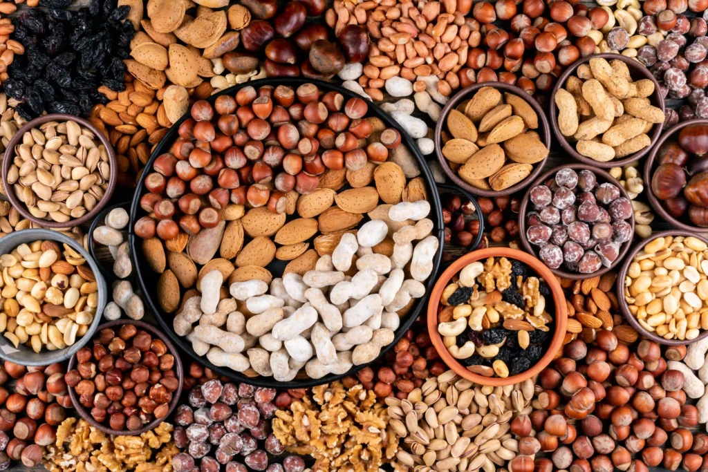 A variety of nuts displayed in bowls, showcasing an assortment of textures and colors for a visually appealing presentation.